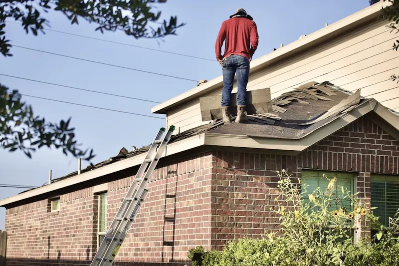 Professional roofer working on a residential roof in New Haven